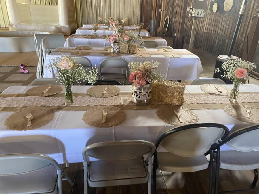 Tables with burlap runners and flower centerpieces