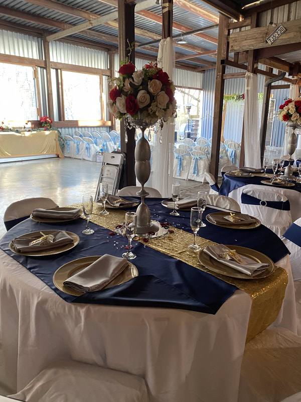 Navy and gold place settings with charger plates on a long table
